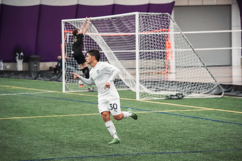 Valentín Sabella points to his teammate, who is not in the frame, after Sabella scored a goal during Hailstorm's first preseason game vs. Harpos FC. 