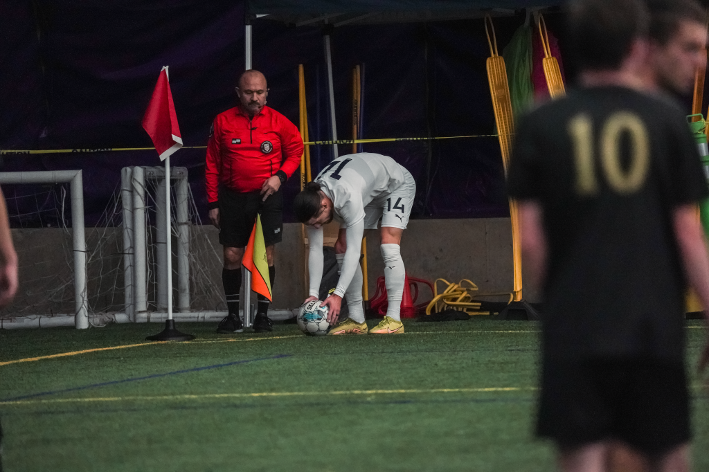 Arthur Rogers sets down the ball for the corner kick during Hailstorm's first preseason game vs. Harpos FC. Rogers is prepared to send a cross using his right foot.