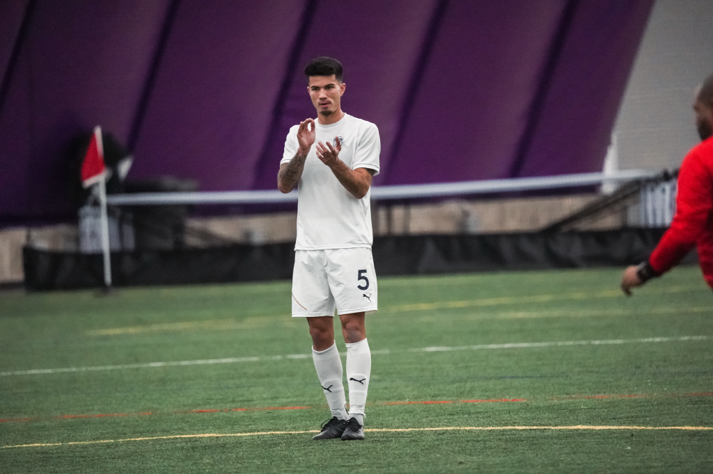 Leo Folla claps for a teammate, who is not pictured in the frame. 